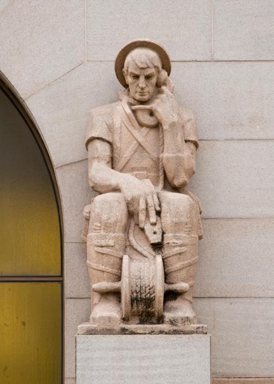 Photograph of the Field Telephone Mechanic buttress sculpture on the Memorial's facade