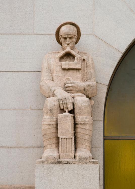 Photograph of the Gas Rescue Man buttress sculpture on the Memorial's facade