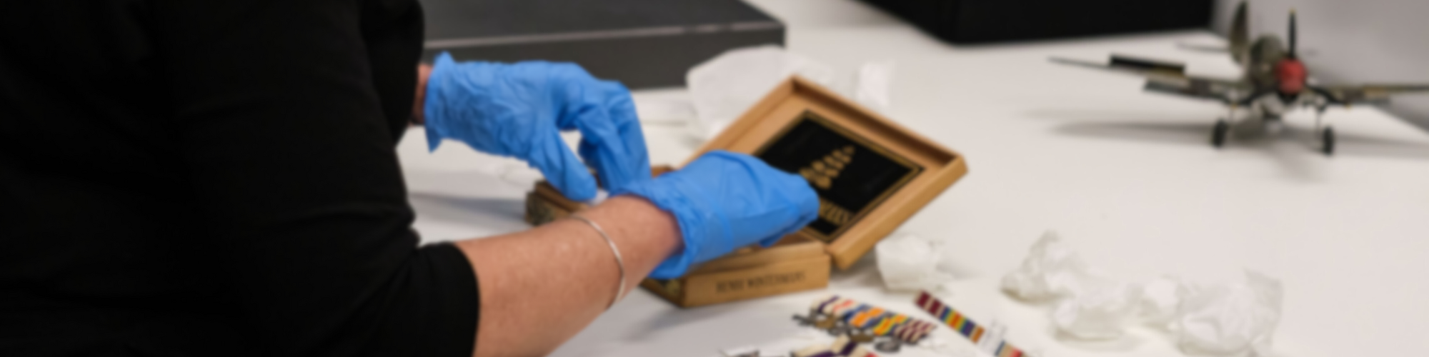 Anzac Memorial Unearthed - hands in an object box