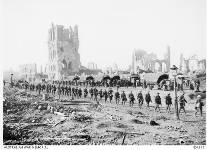 A column of Australian soldiers moving through the town square of Ypres on the way to the front line, October 1917. Note the ruins of the famous Cloth Hall of Ypres in the background, now fully restored as a WW1 museum. Courtesy AWM