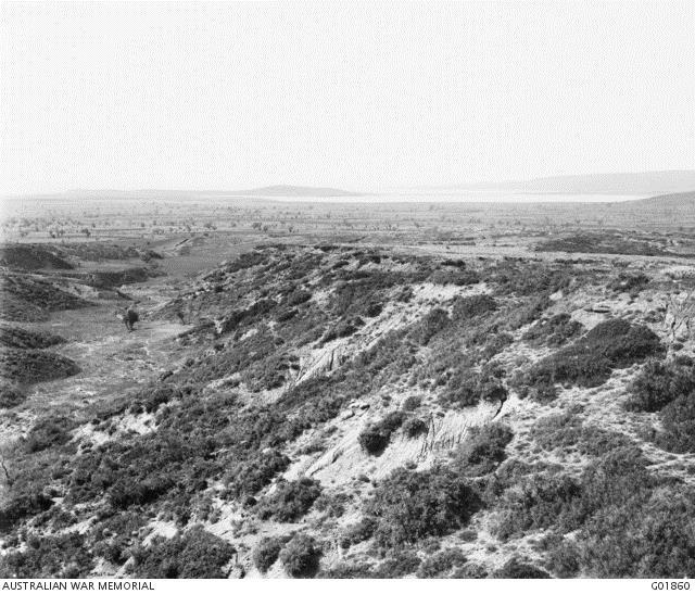 Photo of the Hill 60 feature taken during historian Charles Bean’s visit to the Gallipoli Peninsula in 1919.  Turkish trenches were on the right, along the high ground with Suvla Bay visible in the distance at the top of the picture. Courtesy AWM