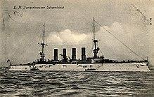 Postcard view of German armoured cruiser SMS Scharnhorst, which along with her sister ship the SMS Gneisenau were two of the capital ships in the German East Asia Squadron operating out of the port of Tsingtao in China during 1914. The enemy squadron’s precise location at sea was unknown, leading the Allies to conduct vigorous patrolling in the Indian Ocean and East Indies waters.