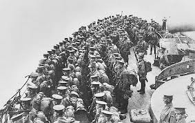 Australian soldiers on parade on the deck of HMS Prince of Wales in Mudros Harbour before the Landing on 25 April 1915. Note the wearing of British flat field caps instead of slouch hats as part of the deception plan to confuse the enemy as to their real identity.  Courtesy AWM