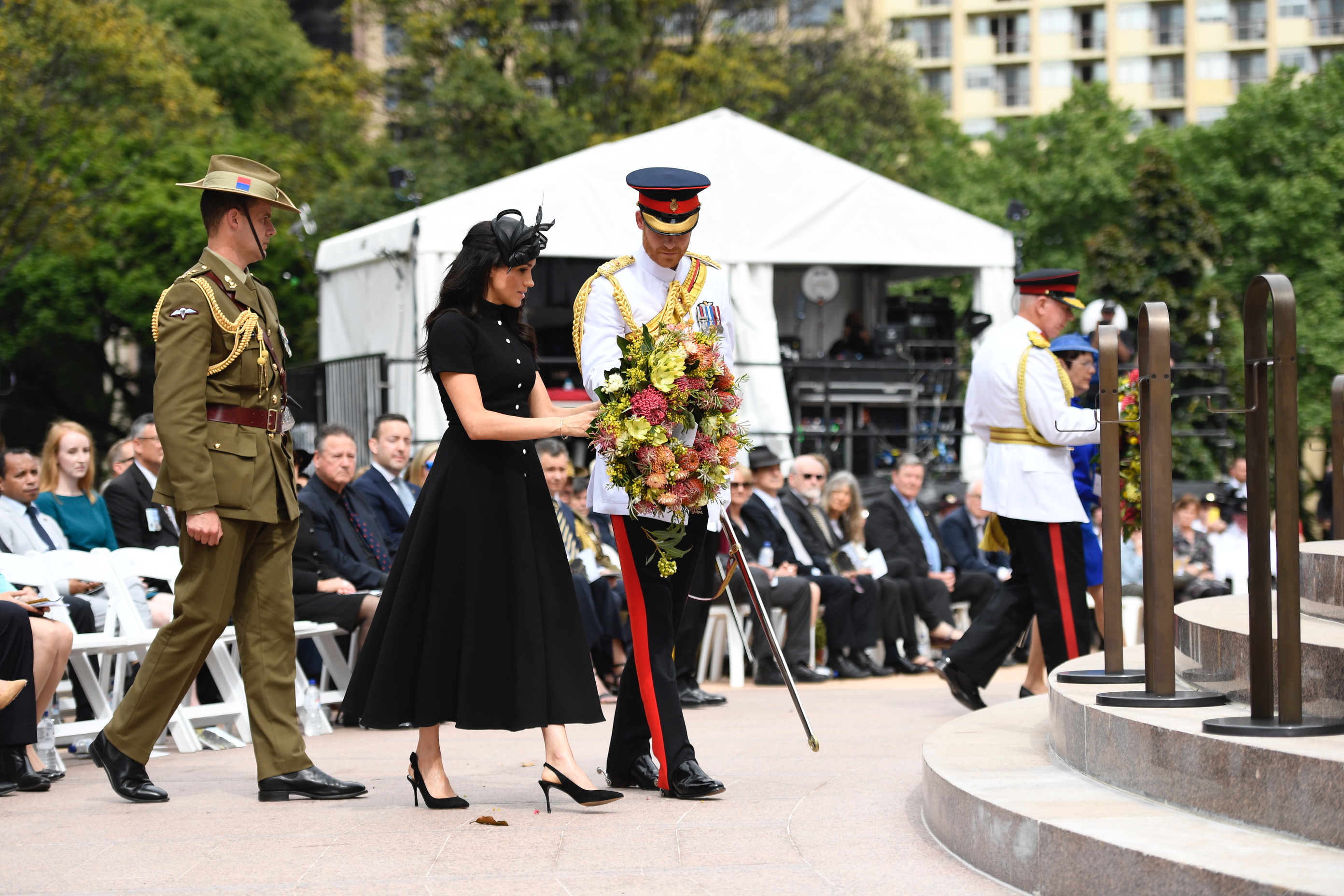 The Duke and Duchess approach the steps of the memorial to lay their wreath