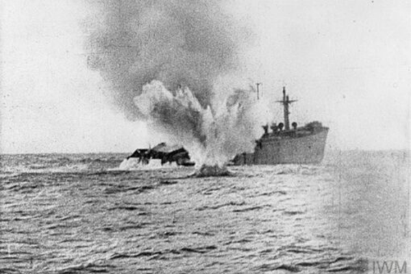 Shipping losses: A U-boat shells a merchant ship which remained afloat after being torpedoed. IWM MISC 51237.