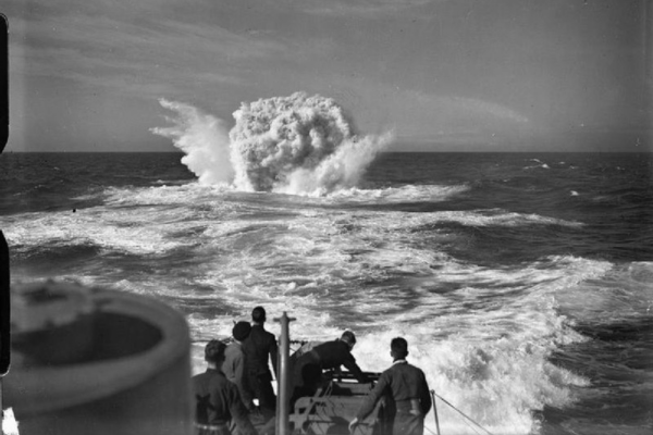 The Royal Navy during the Second World War Depth charges exploding after being dropped by the destroyer HMS VANOC over the spot indicated by the submarine detecting apparatus, which reported a contact during an Atlantic Convoy. Some crew members can be seen at the stern watching the explosion. IWM A 4570.