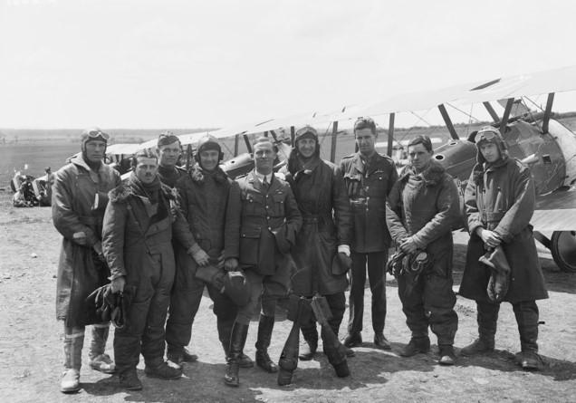 The officers of A Flight, No. 4 Squadron, Australian Flying Corps, in flying gear beside a line-up of Sopwith Camel aircraft. Captain Roy King is fourth from the right. AWM E02661.