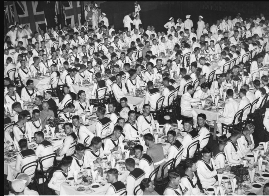 The crew of HMAS 'Sydney' enjoy a luncheon in Sydney Town Hall after the ceremonial welcome home march through George Street. AWM P06554.002.