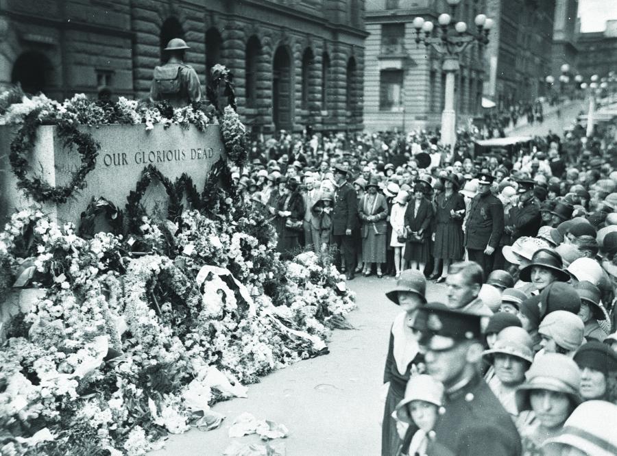 The Cenotaph covered in floral tributes on Anzac Day, 25 April 1930. Courtesy State Library of NSW