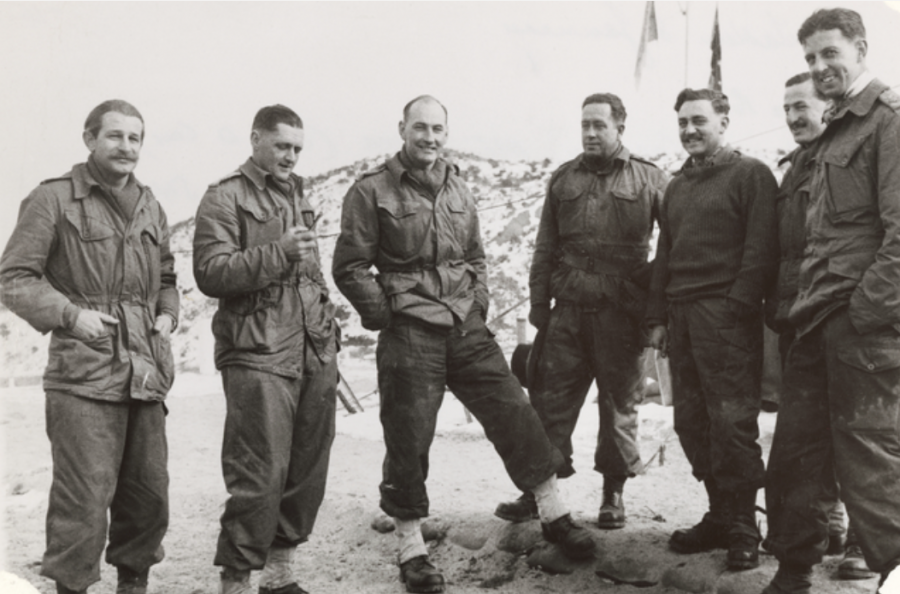 Senior personnel from 3RAR at Battalion Headquarters during operations, c. November 1951. Lieutenant Jim Hughes stands second from the right while Lieutenant-Colonel Frank Hasset stands third from the left. AWM 044485.