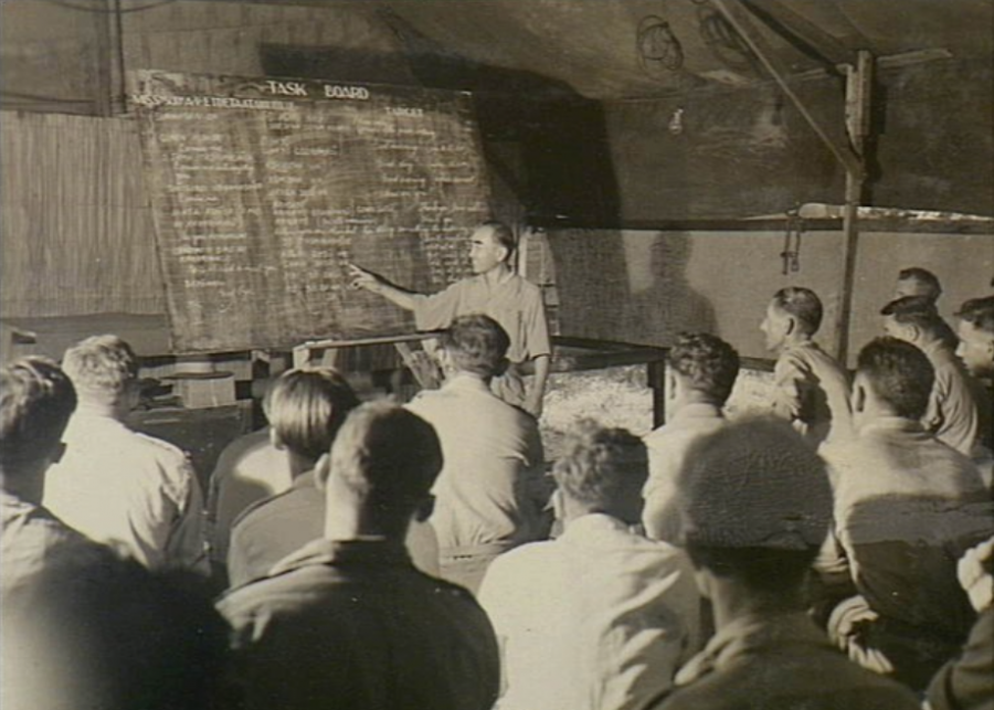 A Major of the Japanese army helps to educate the RAAF’s BCOF volunteers on the trickier points of Japanese phonetics, Labuan Island, North Borneo, 3 November 1945. AWM OG3633.