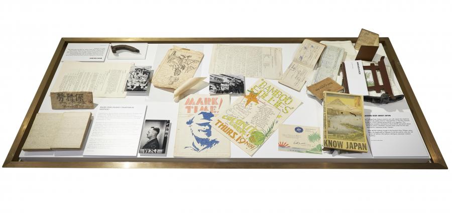 From left to right: armband, diary, documents, camp poster and magazine relating to Major John Champion de Crespigny (gift of ME Serisier); Burma Railway dog spike souvenired by Staff Sgt Thomas Cassidy (gift of John Cassidy); Japanese surrender souvenir leaflet; BCOF personnel information booklet (gift of EJ Collings); BCOF pay books and documents from Cpl James William Bedford (Lent by the Ingleburn Military Precinct Assoc.)