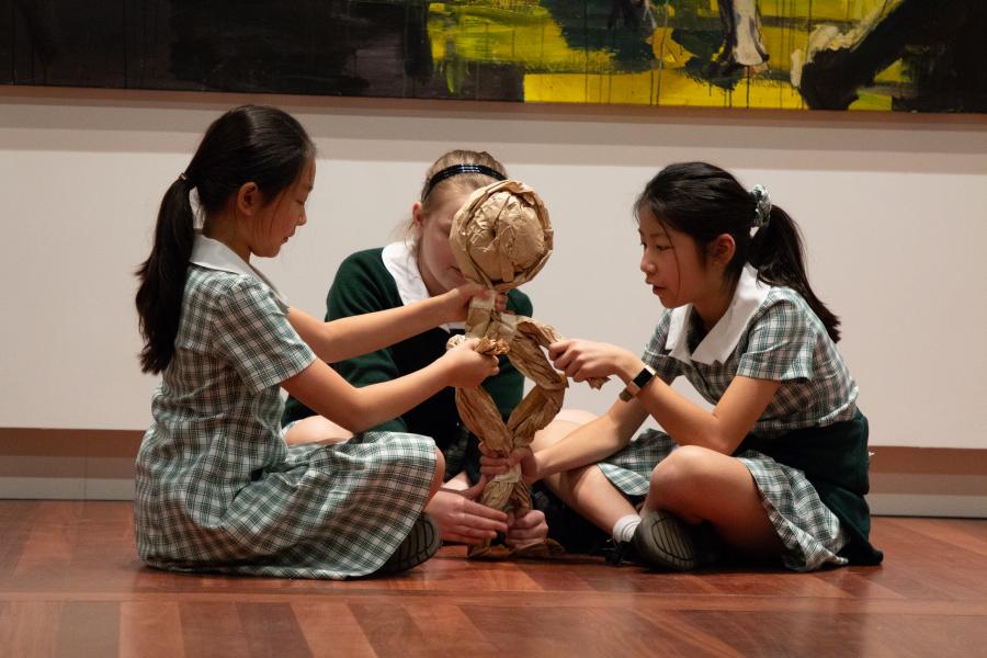 Stage 3 students creating their Anzac puppet with brown paper