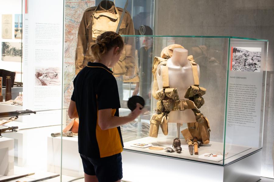 Stage 5 student viewing First World War memorabilia in the Centenary Exhibition