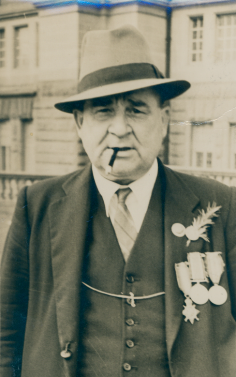 James Smith in middle age, Sydney, likely taken in the year before his death, c. 1948. He wears his Great War medal trio beneath Tin Hat Day buttons and a sprig of Rosemary. Gift of Sue Blaxland (Anzac Memorial Collection 2020.30.44). 