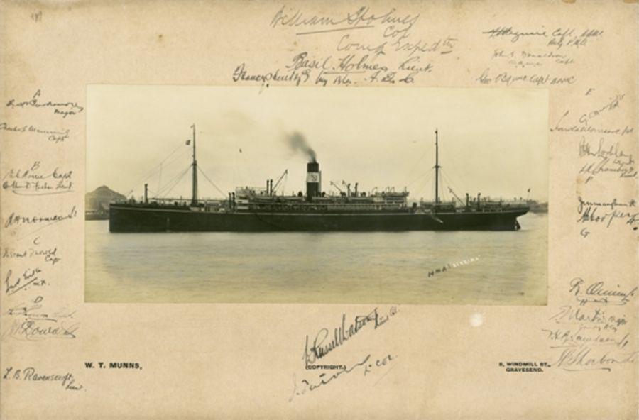 Steamship HMAS (later HMAT) 'Berrima' in an unidentified harbour. Members of the AN&MEF, including the commander Colonel William Holmes, have signed the mount of the photograph. AWM P09552.001.