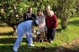 Captain Christine Clarke, of the Royal Australian Navy, collects soil with community members at the Battle of Orakau site in New Zealand.