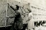 Arthur Buist and Barbara Tribe  applying clay to the bas releif backing board. Courtesy Sylvia Embling archive